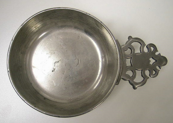 Mint condition pewter bleeding bowl.  Designed to measure the amount of b lood removed from patients.  These bowls can be differentiated from standard pewter porringers by the graduated rings and ounce markings.