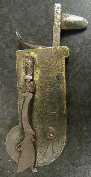 Ornately engraved brass and steel Veterinary spring lancet.  The piece has a beautifully worked release bar.  The item is marked with the makers mark: a reverge "G" and conjoined "B".  The leather case is marked with the GB on either side of what looks like a beehive.  American in origin c.1780-1800.  An identical piece can be found on the Old Sturbridge Village website.