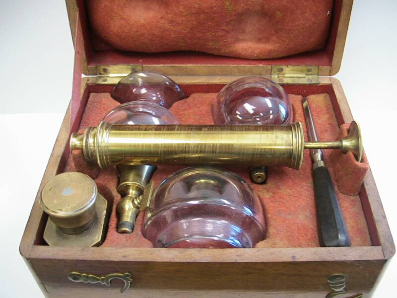 This is a very rare French cupping set / artificial leech combination.  The cups are marked Rosenmund A Paris.  The set contains 2 cups, each fitted with a brass stop-cock mechanism and a breast cupping cup.  All cups fit onto the brass evacuation syringe.  The set also contains a screwdriver to remove the brass fittings from the cups.  The unusual part about this set is the scarificator.